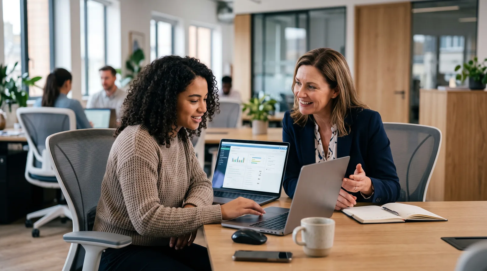 A manager coaching an employee one-on-one through a new process